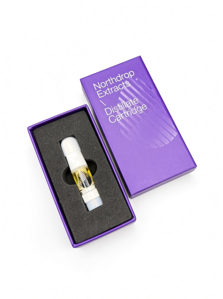 Northdrop Extracts Distillate Cartridge in its opened purple box beside the closed box, shot on white