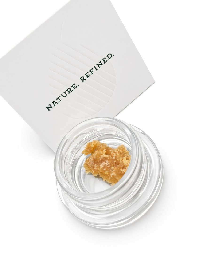 Northdrop Extracts Resin in an open glass jar beside the printed Nature. Refined. card, shot on white